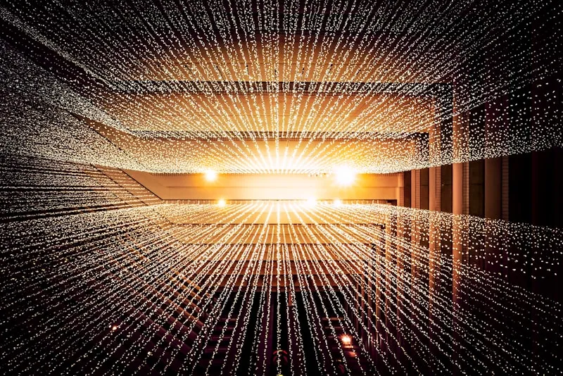 Worm's-eye view of a ceiling with warm light representing upward growth and value