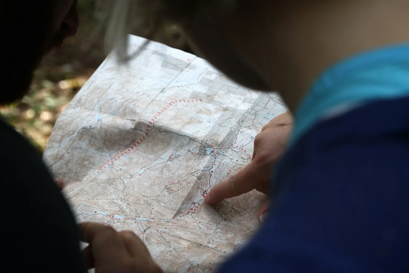 Person pointing at a map while planning a route