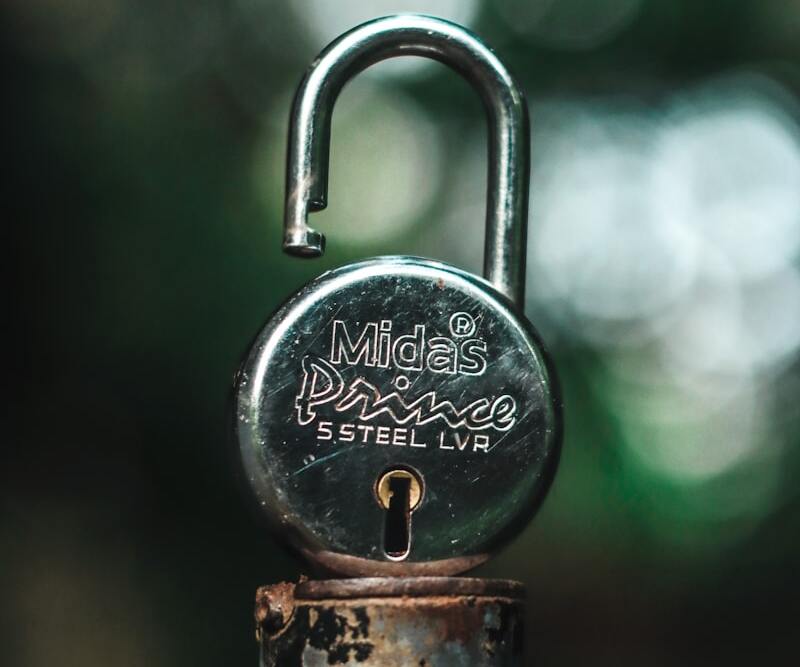 Silver padlock on gray steel handle