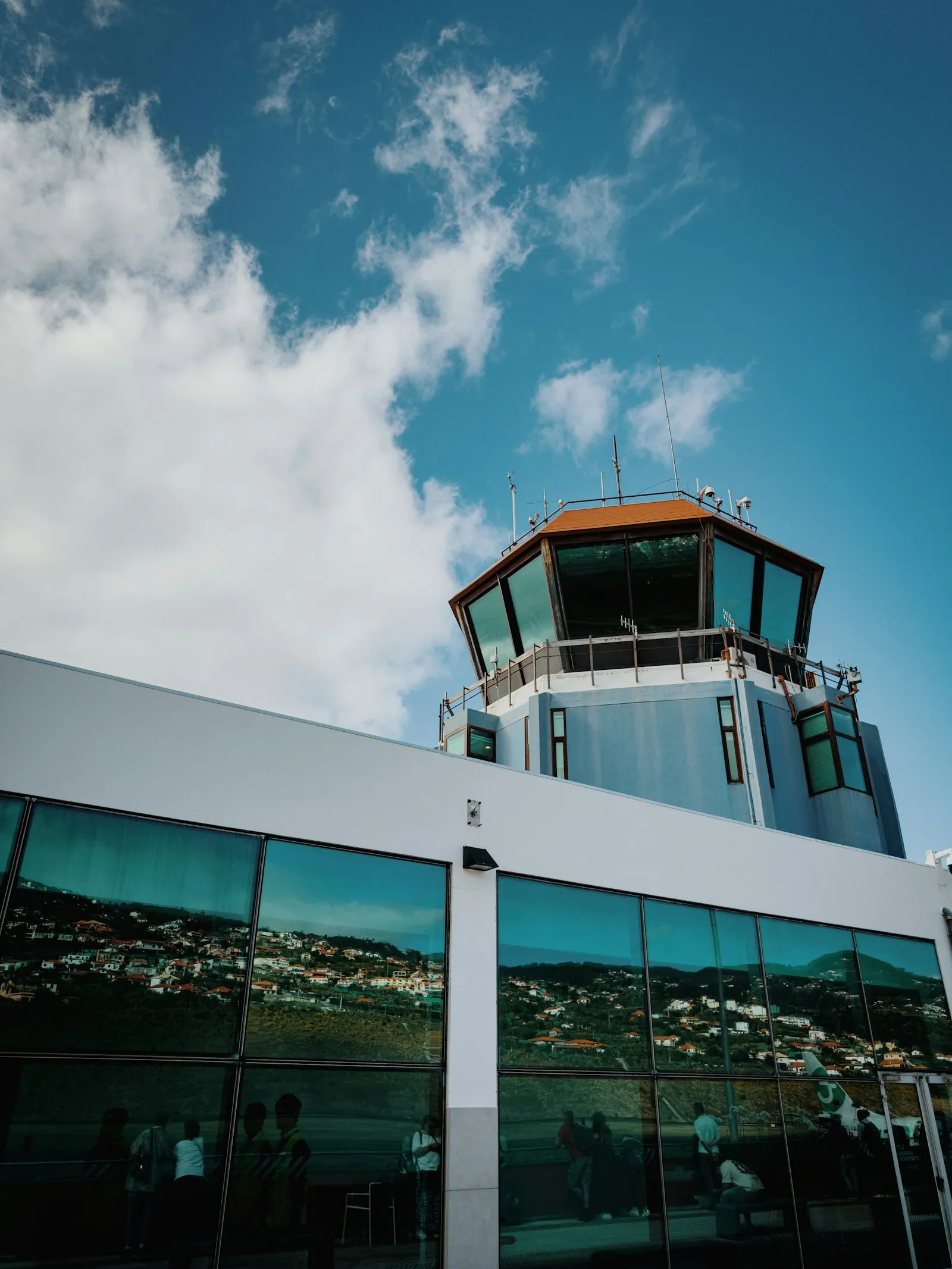 Airport control tower and terminal building under blue sky