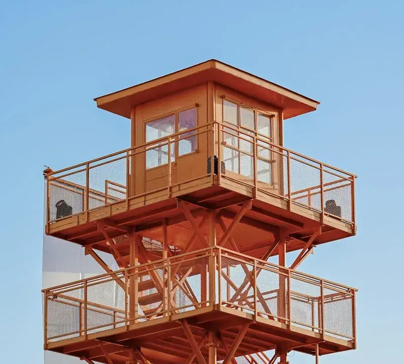 Orange observation tower against a clear blue sky
